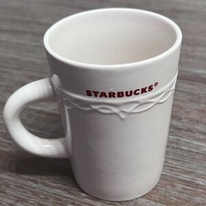 2010 Starbucks White Coffee Mug 10 fl oz Red Lettering‎ Embossed Raised Desgin